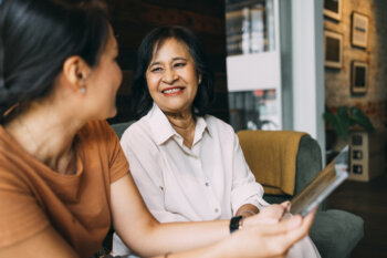 A Happy Beautiful Senior Woman Sitting At A Meeting For Estate Planning